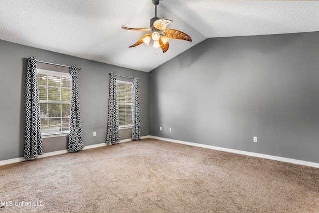 carpeted empty room featuring ceiling fan, a textured ceiling, and vaulted ceiling