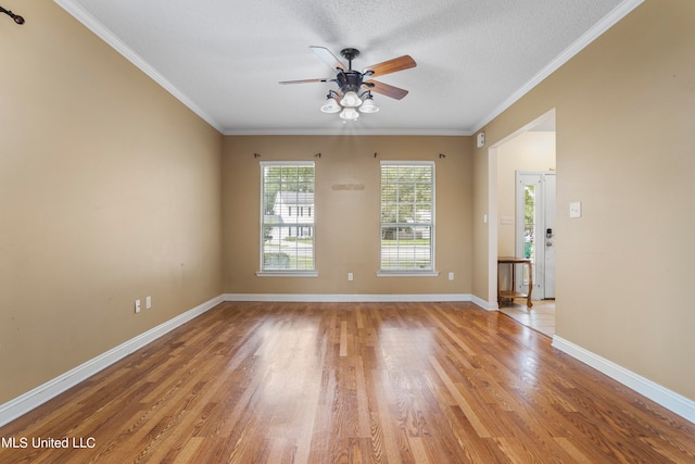 empty room featuring crown molding, a textured ceiling, light wood-type flooring, and ceiling fan