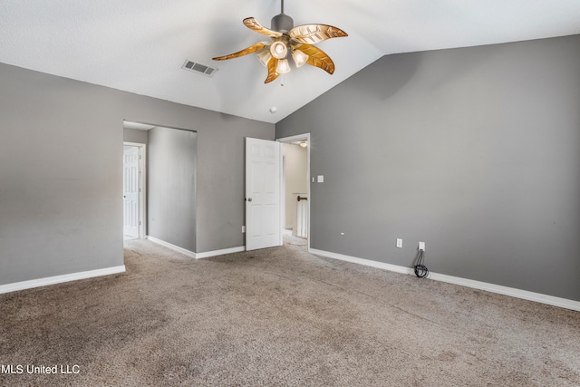 unfurnished bedroom featuring vaulted ceiling, carpet floors, and ceiling fan