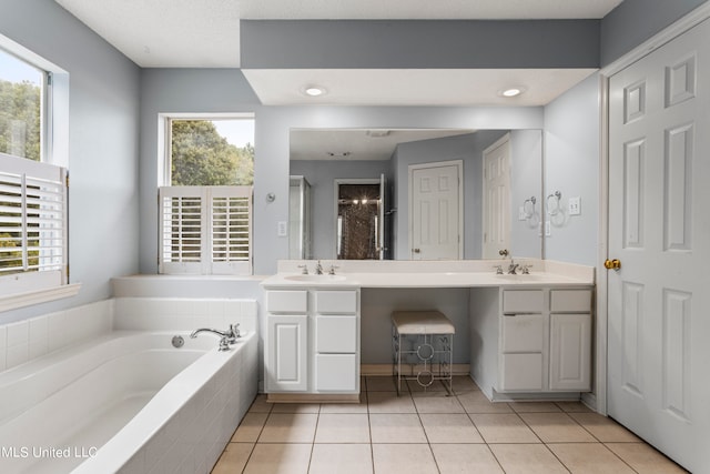 bathroom with vanity, a healthy amount of sunlight, and tile patterned flooring