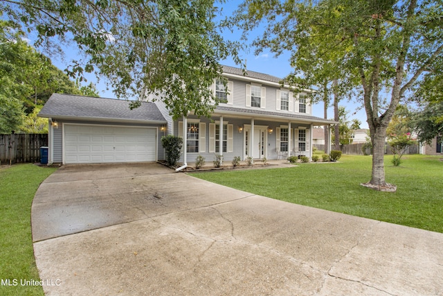 view of front facade with a porch, a front lawn, and a garage