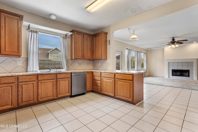 kitchen featuring tasteful backsplash, stainless steel dishwasher, plenty of natural light, and ceiling fan