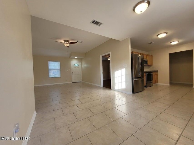 unfurnished living room with light tile patterned floors, visible vents, and baseboards