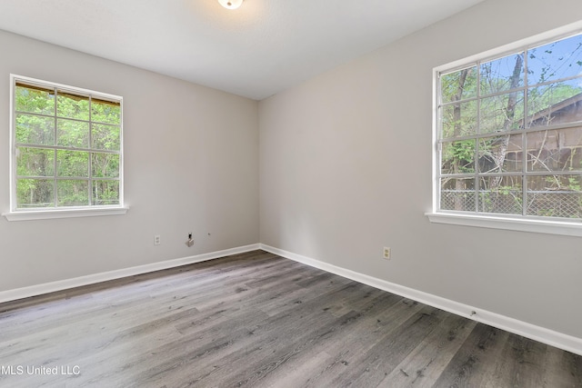 unfurnished room featuring wood finished floors and baseboards