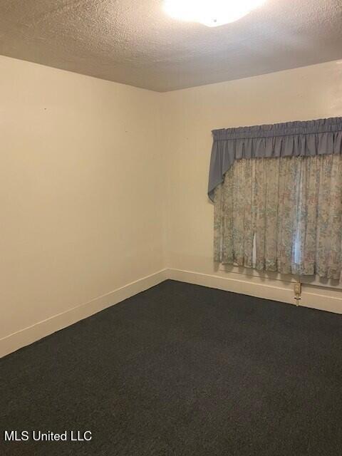 2524 18th Ave, Gulfport, MS 39501 - unfurnished room with baseboards and a textured ceiling