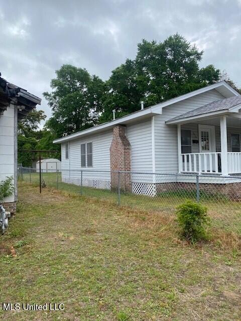 2524 18th Ave, Gulfport, MS 39501 - view of property exterior with fence private yard, a yard, and covered porch