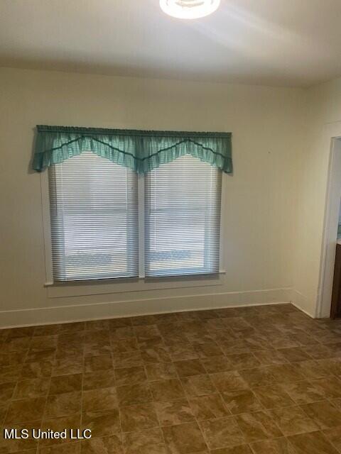 2524 18th Ave, Gulfport, MS 39501 - spare room with baseboards, tile patterned floors, and a healthy amount of sunlight