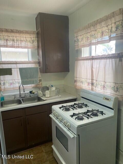 2524 18th Ave, Gulfport, MS 39501 - kitchen with light countertops, white gas stove, a wealth of natural light, and a sink