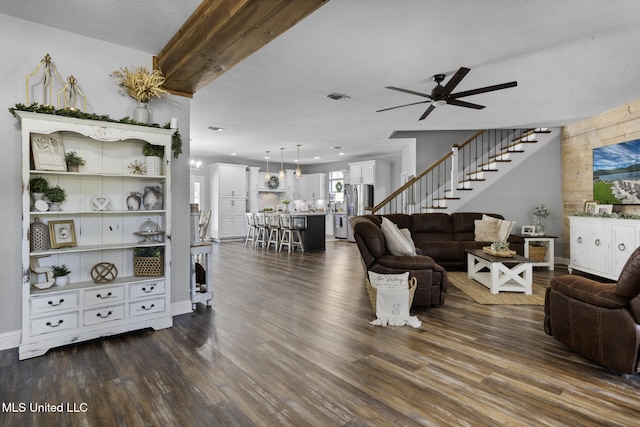 living room featuring dark wood finished floors, stairway, a ceiling fan, and visible vents