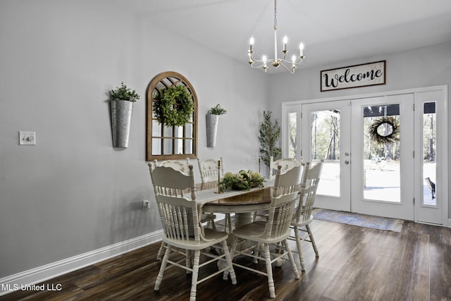 dining room with french doors, baseboards, an inviting chandelier, and dark wood finished floors