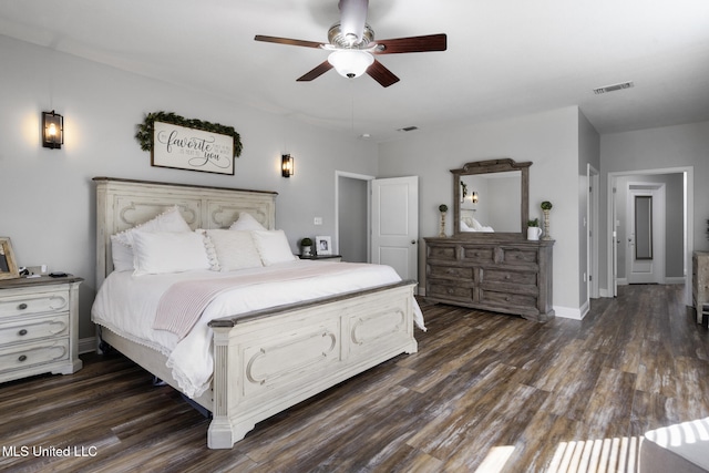 bedroom with dark wood finished floors, visible vents, and baseboards