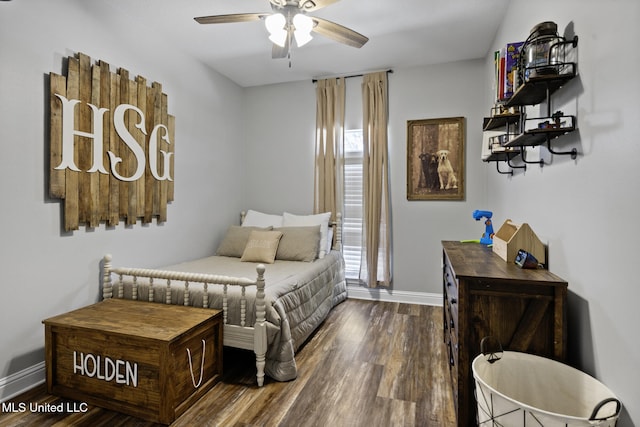 bedroom with a ceiling fan, wood finished floors, and baseboards