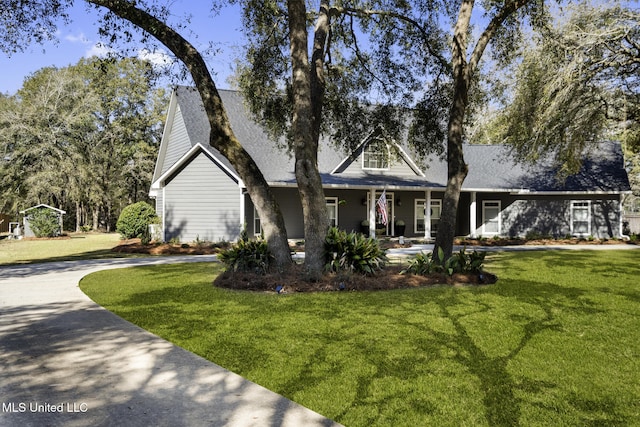 cape cod home featuring driveway and a front yard