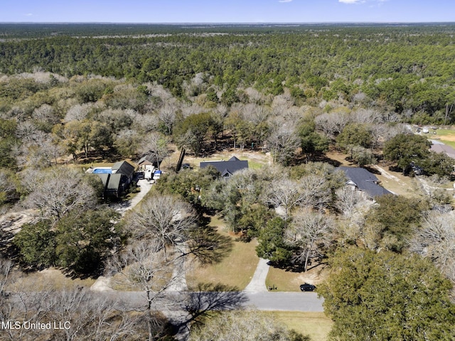 bird's eye view featuring a wooded view