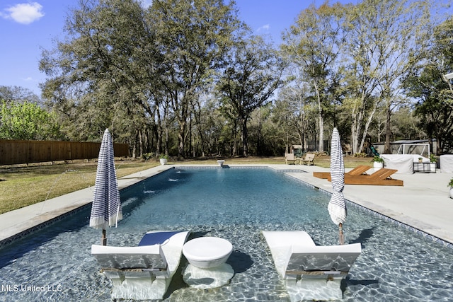 view of pool with a fenced in pool, a patio area, and fence