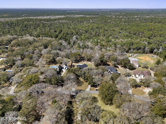 drone / aerial view featuring a wooded view