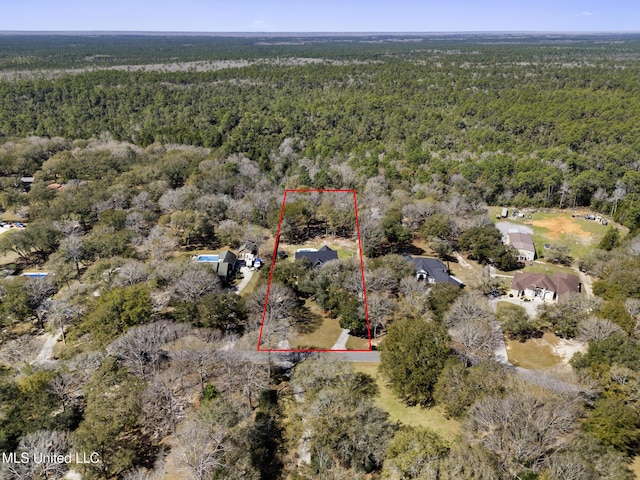 birds eye view of property featuring a view of trees