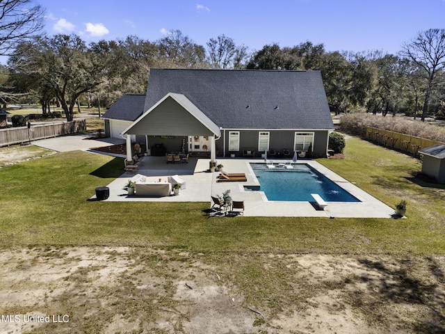 rear view of property featuring a lawn, a patio, and a fenced backyard