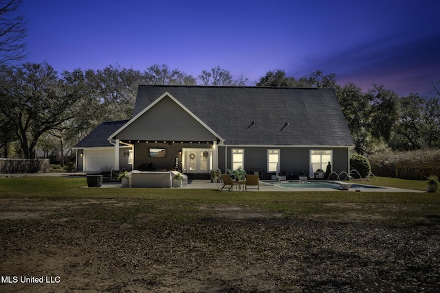 back of property at dusk featuring an outdoor pool, french doors, and a patio