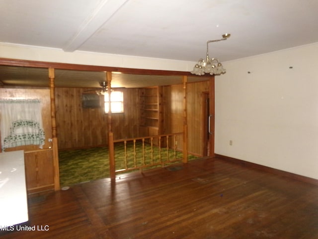 interior space with wooden walls, baseboards, and wood finished floors