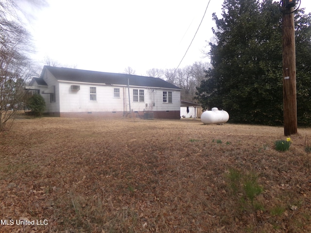 view of front of house with crawl space, a carport, and central AC unit