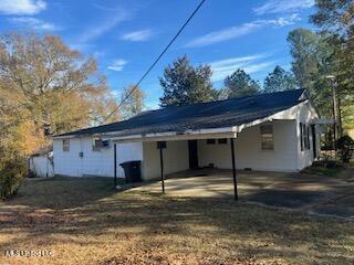 rear view of property with a carport