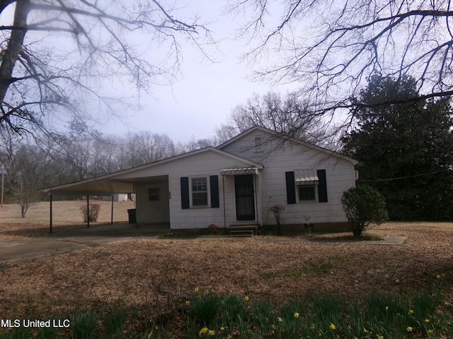 view of front of house with an attached carport, driveway, and entry steps