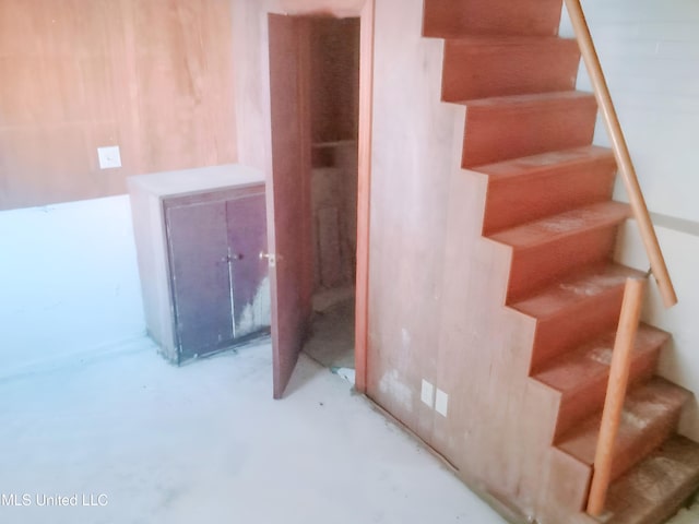 stairway with concrete flooring