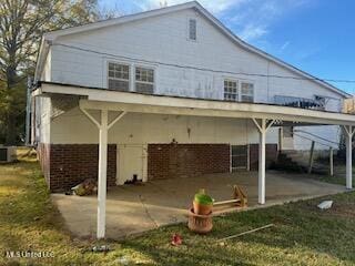 rear view of property with a patio and a yard