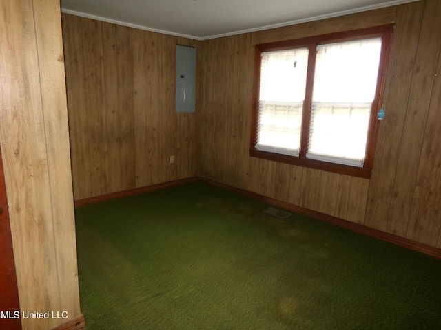 carpeted spare room featuring electric panel, visible vents, and baseboards