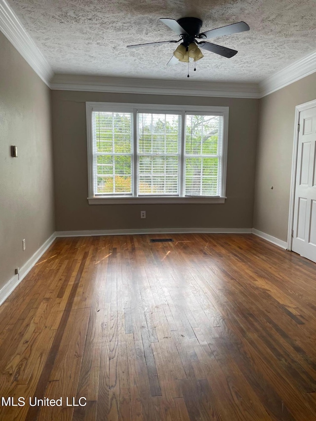 unfurnished room with ceiling fan, a textured ceiling, dark hardwood / wood-style floors, and ornamental molding