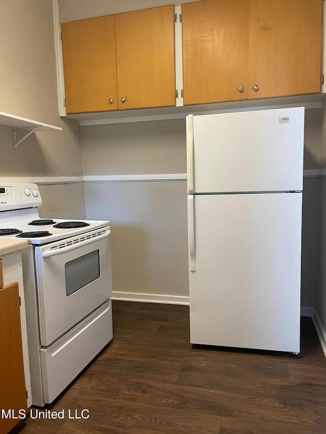 kitchen featuring dark wood-type flooring and white appliances