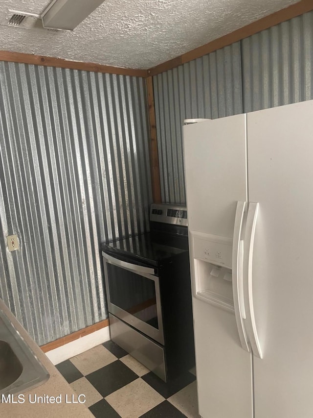 kitchen with white refrigerator with ice dispenser, stainless steel electric stove, and a textured ceiling