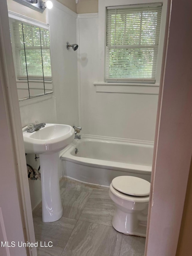 bathroom featuring toilet, tile patterned flooring, and sink