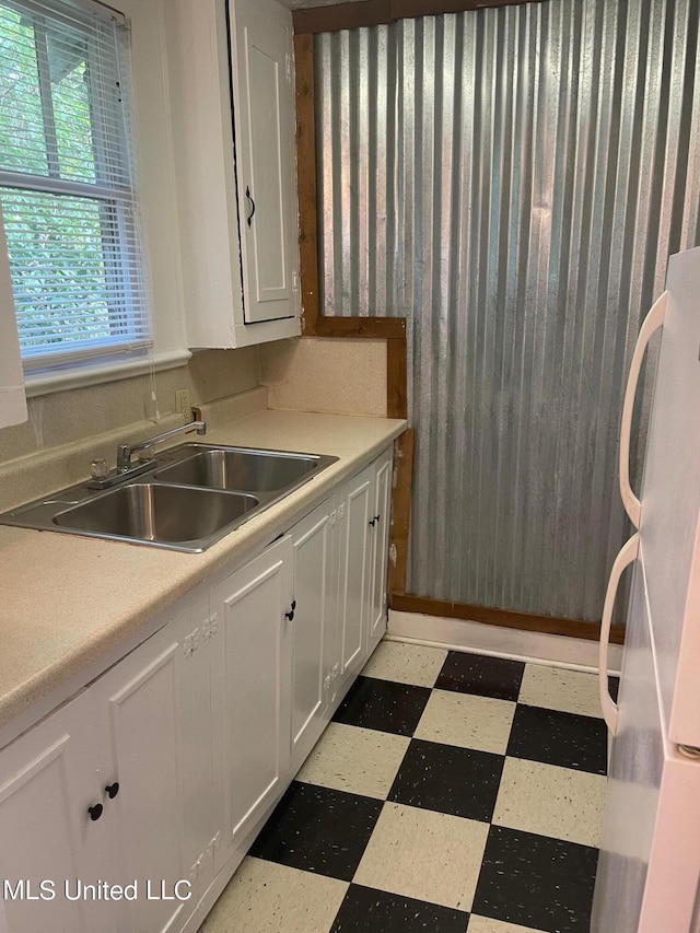 kitchen with sink, white cabinets, and white fridge