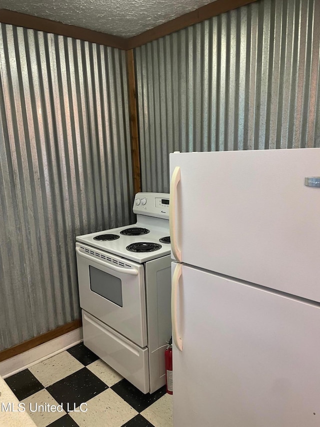 kitchen featuring white appliances and a textured ceiling