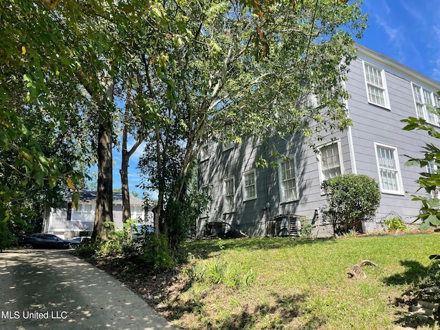 view of property exterior featuring a lawn