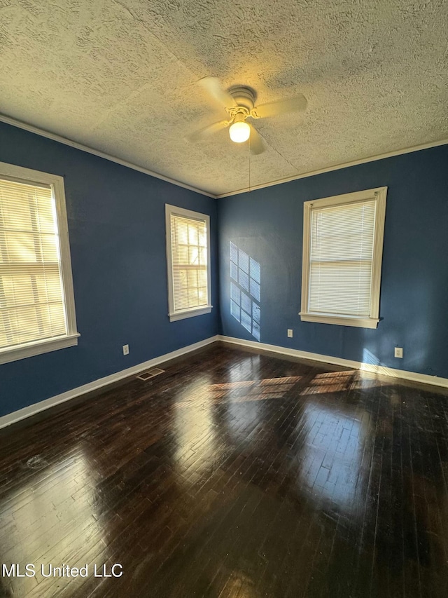 unfurnished room with ceiling fan, plenty of natural light, a textured ceiling, and hardwood / wood-style flooring