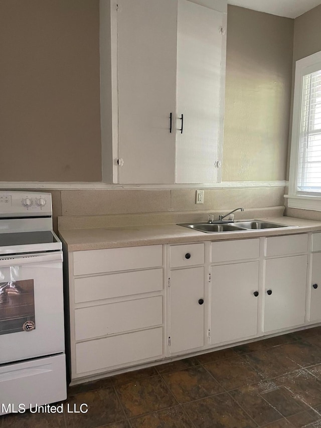 kitchen featuring white cabinetry, sink, and white range with electric stovetop