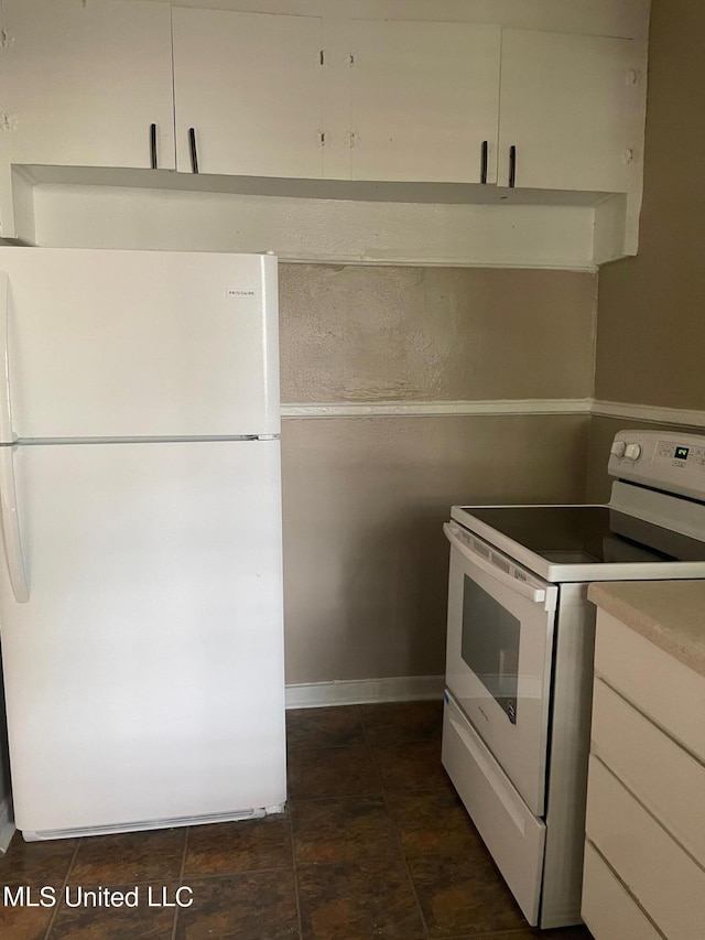 kitchen featuring white cabinets and white appliances