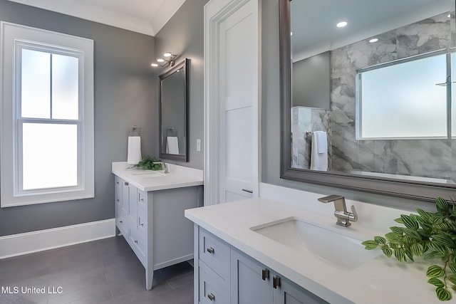 bathroom featuring ornamental molding, vanity, and a healthy amount of sunlight