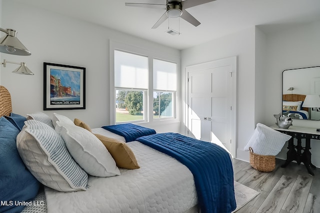 bedroom with light wood-type flooring and ceiling fan