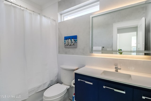 full bathroom with toilet, vanity, tile walls, and shower / bath combination with curtain