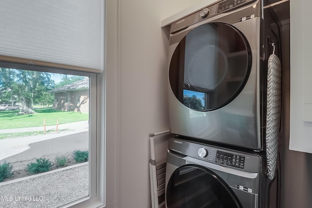 laundry area with stacked washer and clothes dryer