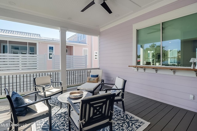 wooden deck featuring an outdoor fire pit and ceiling fan