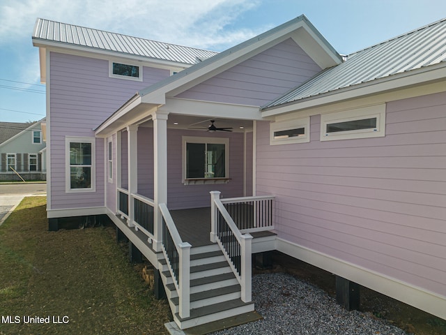 rear view of property with ceiling fan