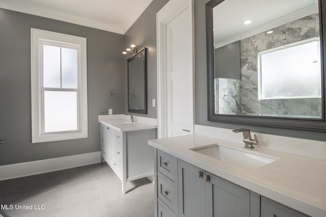 bathroom with a wealth of natural light, vanity, and ornamental molding