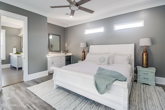 bedroom with ornamental molding, light wood-type flooring, ceiling fan, and ensuite bathroom