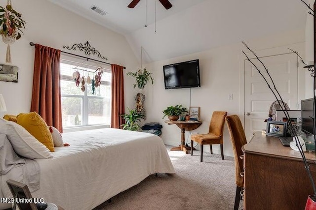 carpeted bedroom with visible vents, a ceiling fan, and vaulted ceiling