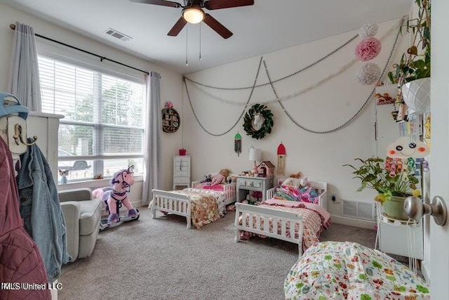 carpeted bedroom with visible vents and ceiling fan